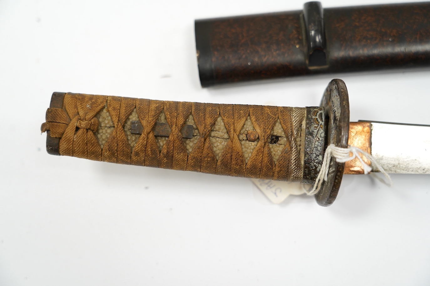 A 19th century Japanese wakizashi with scabbard, blade 31.5cm. Condition - fair, age worn overall
